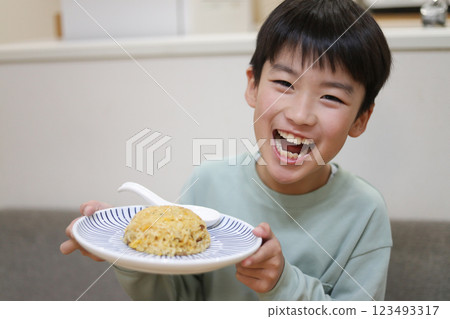 Boy eating fried rice Boy eating fried rice 123493317