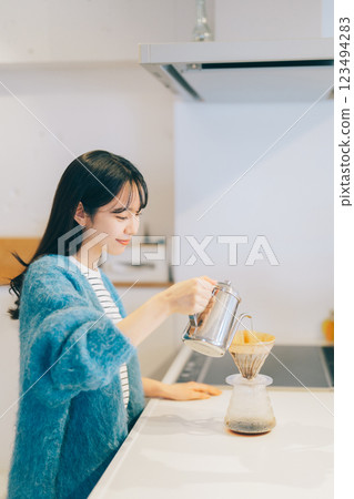 Woman brewing coffee in the kitchen Woman brewing coffee in the kitchen 123494283
