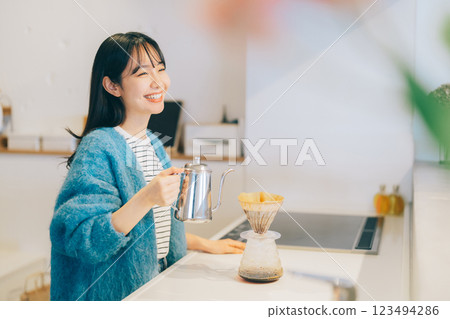 Woman brewing coffee in the kitchen Woman brewing coffee in the kitchen 123494286