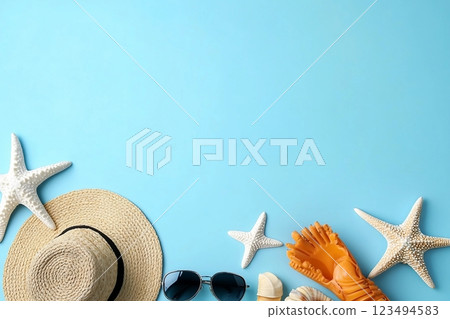 Beach accessories on light blue background, flat lay. Space for text Beach accessories on light blue background, flat lay. Space for text 123494583