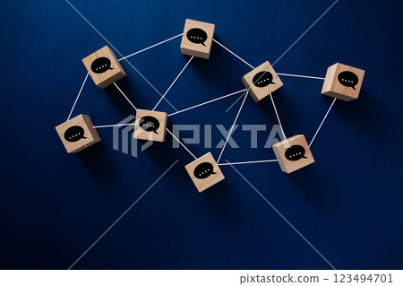 Wooden cubes representing a business network communicating with each other 123494701