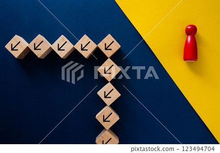 Red manager changing direction, taking a different path from wooden blocks with arrows 123494704