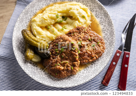 Inverted Beef Schnitzel with Mashed Potatoes and Pickled Cucumbers. Traditional Czech and Slovak Food 123494833