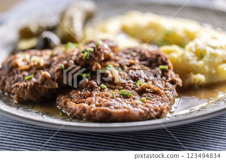 Inverted Beef Schnitzel with Mashed Potatoes and Pickled Cucumbers. Traditional Czech and Slovak Food Inverted Beef Schnitzel with Mashed Potatoes and Pickled Cucumbers. Traditional Czech and Slovak Food 123494834