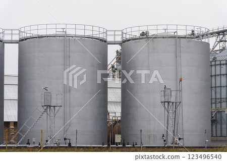 This agro-processing facility features several large silos designed for storing harvested grains. The silos are integral to grain storage and processing operations This agro-processing facility features several large silos designed for storing harvested grains. The silos are integral to grain storage and processing operations 123496540