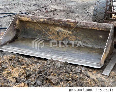 A bobcat is positioned next to a bulldozer and tractor at a construction site. The ground is disturbed, indicating active land preparation for upcoming work 123496718