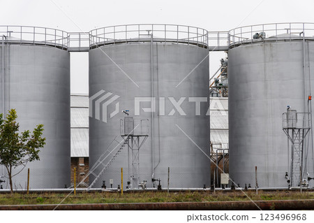 Three large fuel storage silos stand prominently in an industrial area, reflecting the importance of fuel management in supporting nearby facilities and operations 123496968