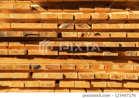 Folding wooden planks in a sawmill. Wooden boards. Background of boards 123497176