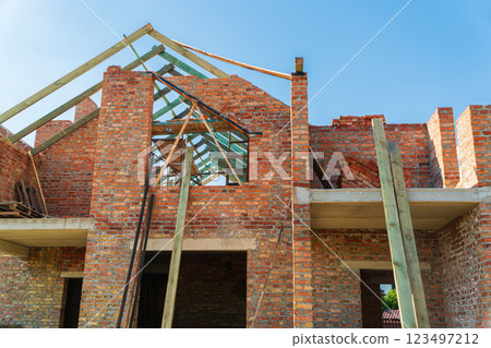 Construction of a house. Construction of a red brick house. Modern construction Construction of a house. Construction of a red brick house. Modern construction 123497212