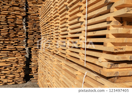 Wooden boards, lumber, industrial wood, timber. Stacked wooden boards at lumberyard Wooden boards, lumber, industrial wood, timber. Stacked wooden boards at lumberyard 123497405