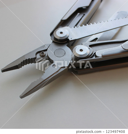 Pliers Jaws of Professional Folding Multi Tool with Variety Blades and Metal Handles Detailed Image. Compact All in One Tool Kit Fully Made of Steel Pliers Jaws of Professional Folding Multi Tool with Variety Blades and Metal Handles Detailed Image. Compact All in One Tool Kit Fully Made of Steel 123497408