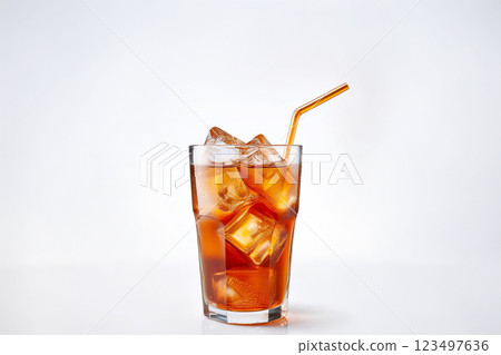Iced tea poured into a glass filled with ice 123497636