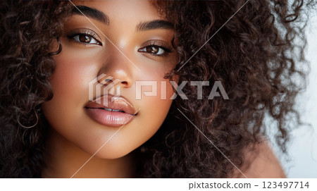 Close-up portrait of a young woman with curly hair 123497714