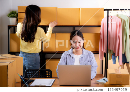 Two young asian businesswoman checking order of customer for laptop computer and document. Two young asian businesswoman checking order of customer for laptop computer and document. 123497959