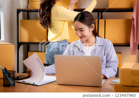 Two young asian businesswoman checking order of customer for laptop computer and document. Two young asian businesswoman checking order of customer for laptop computer and document. 123497960