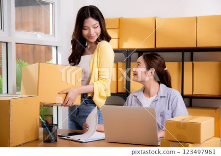 Two young asian businesswoman checking order of customer for laptop computer and document. Two young asian businesswoman checking order of customer for laptop computer and document. 123497961