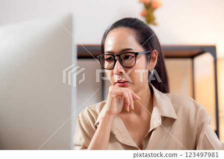 Young asian business woman working with desktop computer while thinking for planning financial. 123497981