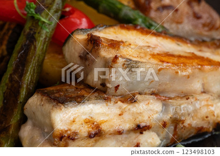 Succulent, grilled fish served with vibrant asparagus and roasted red peppers, showcasing a delicious arrangement of colorful, healthy ingredients. Succulent, grilled fish served with vibrant asparagus and roasted red peppers, showcasing a delicious arrangement of colorful, healthy ingredients. 123498103