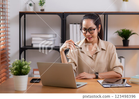 Happiness young businesswoman using laptop computer on desk in living room at home office. Happiness young businesswoman using laptop computer on desk in living room at home office. 123498396