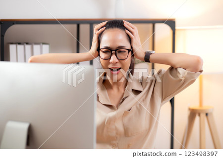 Unhappy young asian businesswoman using desktop computer with frustrated and stress. Unhappy young asian businesswoman using desktop computer with frustrated and stress. 123498397