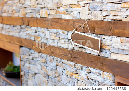directional arrow sign on stone wall directional arrow sign on stone wall 123498588