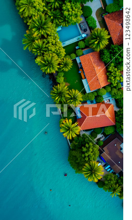 Aerial view of a tropical resort surrounded by palm trees Aerial view of a tropical resort surrounded by palm trees 123498642