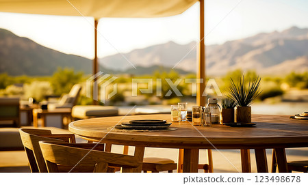 A wooden table with a view of the mountains in the background A wooden table with a view of the mountains in the background 123498678