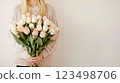 A woman holding a bouquet of white and pink roses 123498706