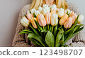 A woman holding a bouquet of white and pink tulips 123498707