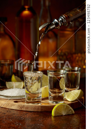 Gold tequila with salt and lime slices. Gold tequila with salt and lime slices. 123498782