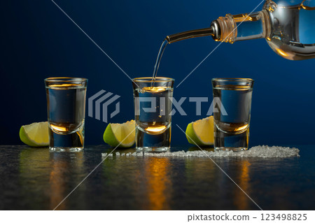 Tequila with lime and salt on a stone table. 123498825