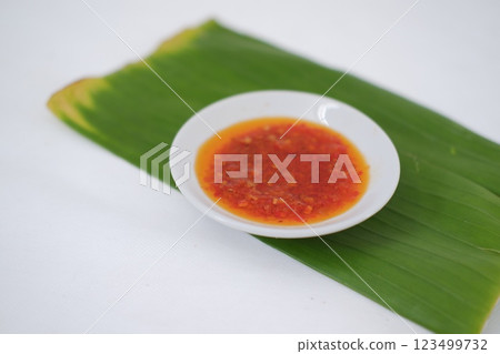 Thai style chili paste on banana leaf on a white background. 123499732