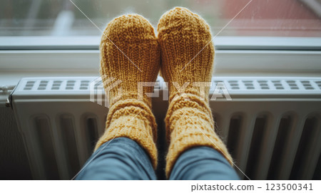Warm Yellow Wool Socks on Radiator 123500341
