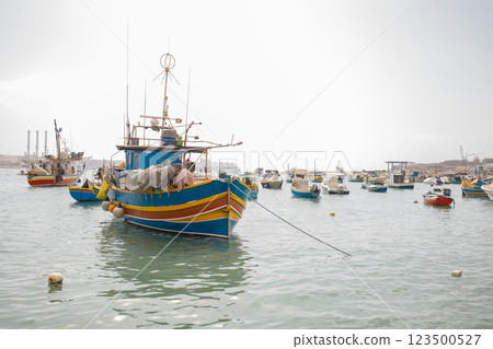 Colorful maltese ships and boats in Marsaxlokk fishers village on Malta 123500527
