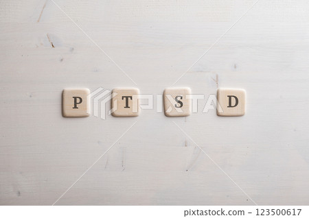 PTSD spelled over four wooden cut squares PTSD spelled over four wooden cut squares 123500617