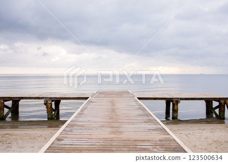 Wooden pier on empty beach by the Baltic sea in Sopot, Poland 123500634