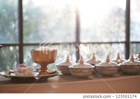 Thai bowl set on table prepare for give food offerings to a Buddhist monk in the morning. People usually prepare rice, dishes and flower offer food to monk. Thai bowl set on table prepare for give food offerings to a Buddhist monk in the morning. People usually prepare rice, dishes and flower offer food to monk. 123501174