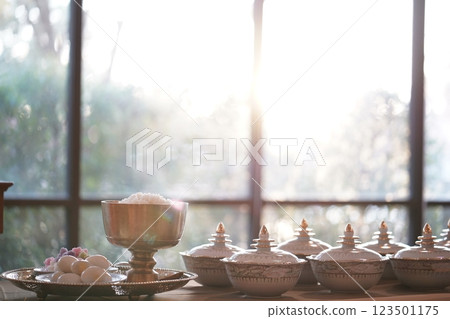 Thai bowl set on table prepare for give food offerings to a Buddhist monk in the morning. People usually prepare rice, dishes and flower offer food to monk. 123501175