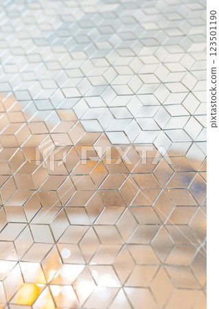 Shiny mirror cut in a cube shape for decorating wall and floor, laying mirror tile in 3d cube geometric pattern. 123501190