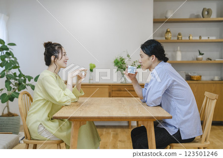 Image of a couple in their 40s relaxing in their living room Image of a couple in their 40s relaxing in their living room 123501246