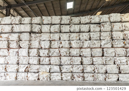 The natural Thai standard rubber bales sheet products staked and stored in the factory warehouse. The storage procession product of a rubber factory. The natural Thai standard rubber bales sheet products staked and stored in the factory warehouse. The storage procession product of a rubber factory. 123501429