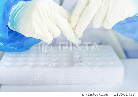 Close up to the rubber gloves on the asian medical staff is processing coronavirus or covid-19 test in the negative room pressure. 123501438