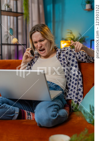Furious annoyed young woman freelancer engage in heated phone conversations quarrel frustration Furious annoyed young woman freelancer engage in heated phone conversations quarrel frustration 123501522