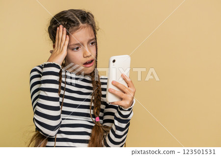 Upset sad child girl use smartphone play game loses loss fail unlucky news bad lottery result crisis 123501531