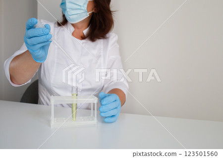 Medical laboratory nurse making urine test 123501560