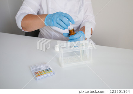 Medical nurse preparing workplace for making express urine test in clinical laboratory 123501564