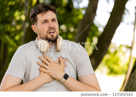 Sports man runner jogger having heart attack or chest pain after running workout in urban city park Sports man runner jogger having heart attack or chest pain after running workout in urban city park 123501583