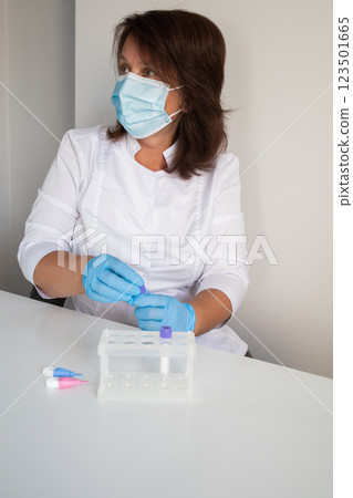 Medical laboratory nurse preparing workplace for making children blood tests Medical laboratory nurse preparing workplace for making children blood tests 123501665
