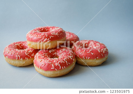 Pink donuts on blue background with copy space 123501975