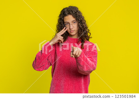 Young girl pointing at eyes and camera show I am watching you gesture spying, watching on someone 123501984